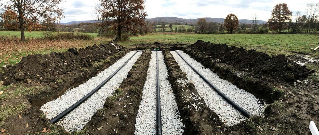 Open excavation for a residential septic tank and drainfield in loamy soil
